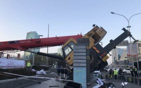 吓坏了！北京闹市一吊车侧翻，差1米就砸进商场，压坏地铁口